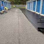 Crew sealcoating the drive lane at a self-storage facility in Loveland, CO