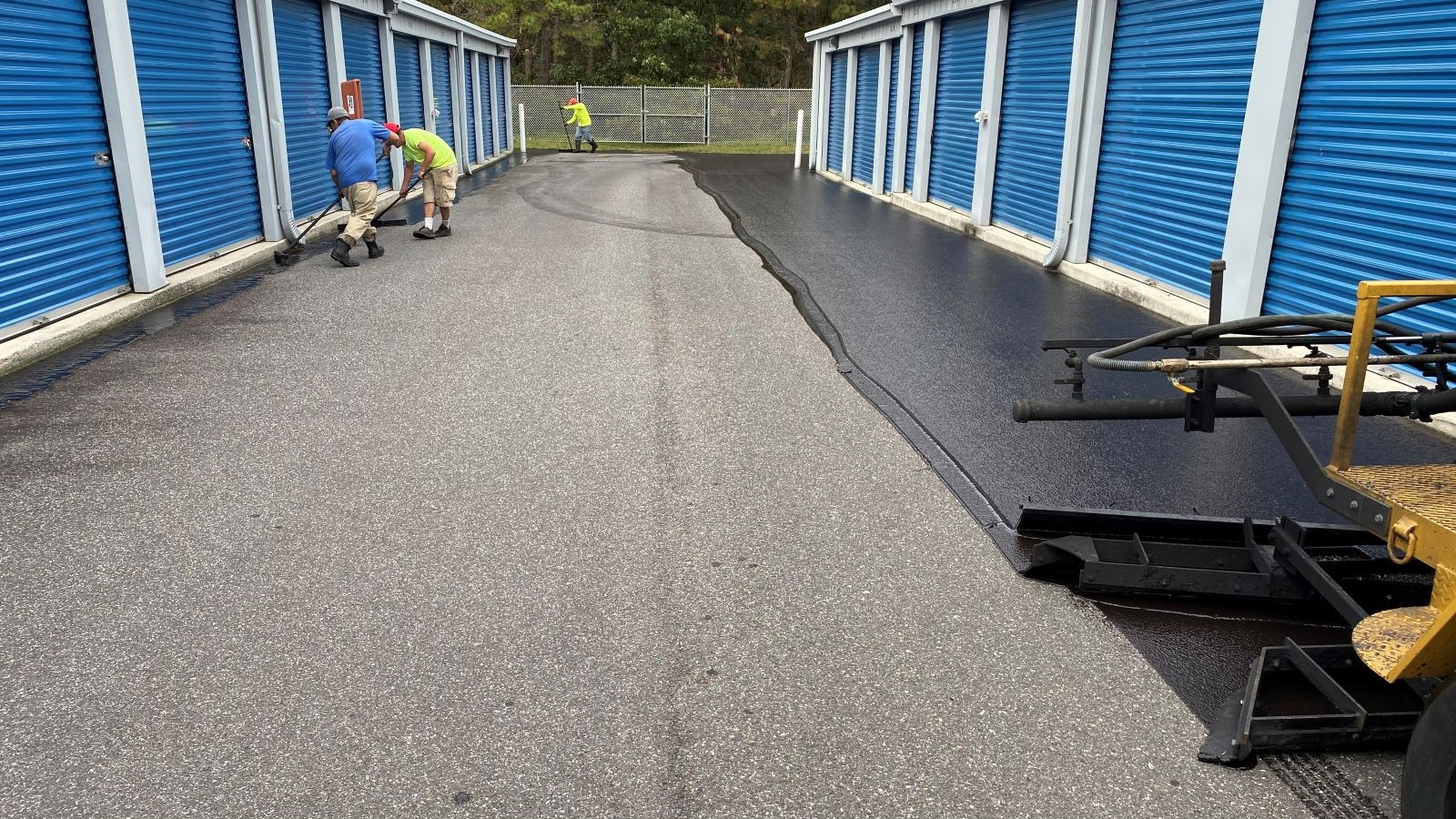 Crew sealcoating the drive lane at a self-storage facility in Loveland, CO